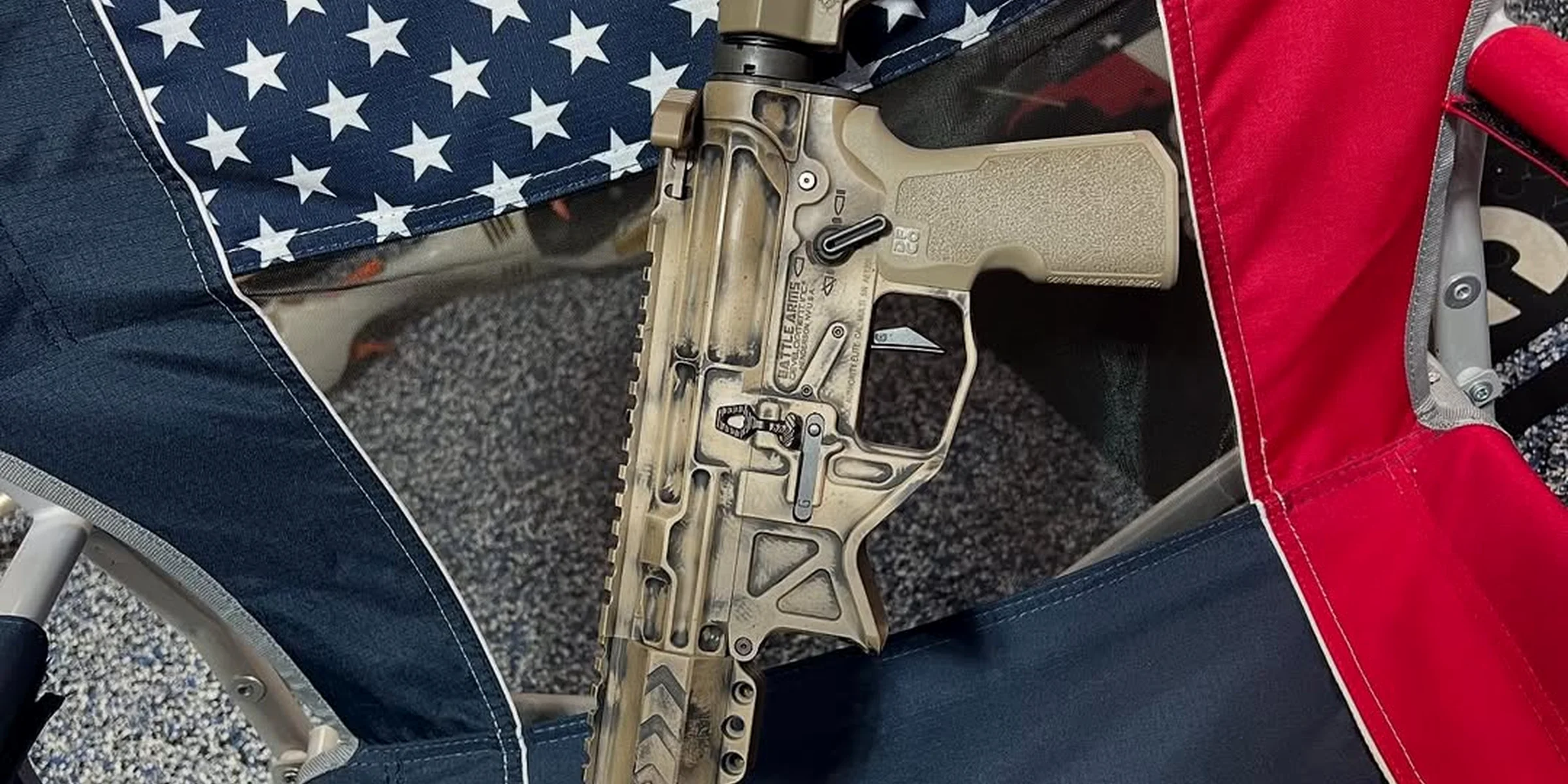 Texas Coastal Armory custom rifle displayed against an American flag
