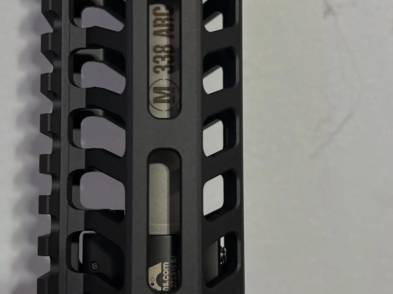 Close detail of an M-LOK handguard and barrel interface